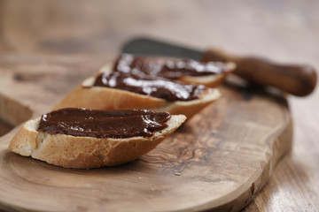 baguette slices with homemade hazelnut cream gianduja on cutting board