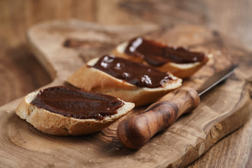 baguette slices with homemade hazelnut cream gianduja on cutting board