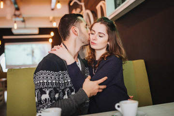 Fototapeta premium Couple in love. Romantic date of couple in love in cafe. Happy couple enjoying romantic moment in cafe. Love story.