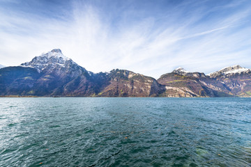 Alps Canton of Uri. Switzerland. Mountain landscape. Windy day on the lake. Dynamic clouds in the sky.