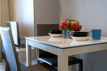 Dinding table with flower and plates in comfortable room