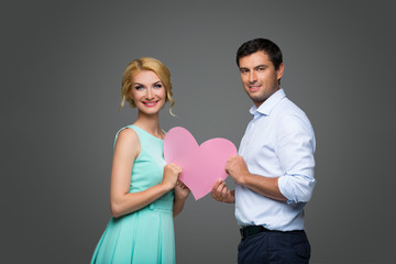 Beautiful couple holding pink heart