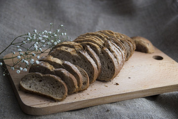 sliced loaf of bread on a board and sacking