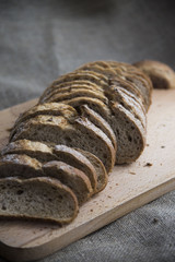 sliced loaf of bread on a board and sacking