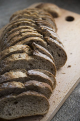 sliced loaf of bread on a board and sacking