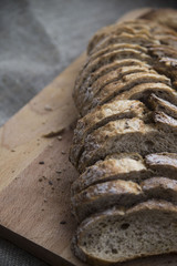 sliced loaf of bread on a board and sacking