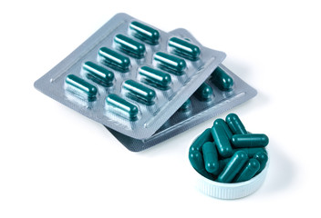 Aluminium blister pack of pills. The capsules are packaged in blisters, isolated on a white background. Disease. Flu. Medications.