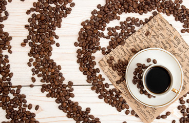 Cup of coffee, roasted coffee beans. Top view