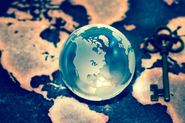 Crystal Globe with Key on Grunge World Map