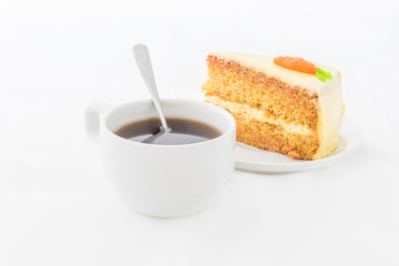 Carrot Cake on white dish with hot drink