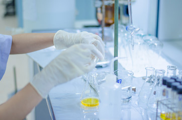 Scientist hand titration at laboratory, titrate chemical, titration with burette and erlenmeyer flask. erlenmeyer flask and test tube.