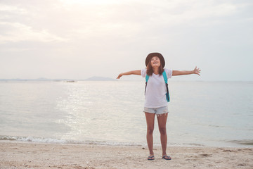 Fototapeta na wymiar Happy young woman having fun on her vacation,holding backpack,St