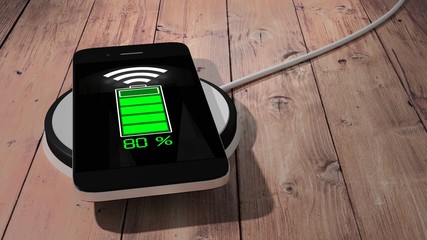 Wireless charging pad with mobile phone on wooden table