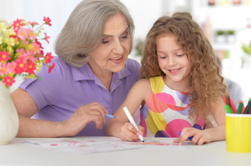 Obraz na płótnie Canvas grandmother helping her granddaughter doing homework