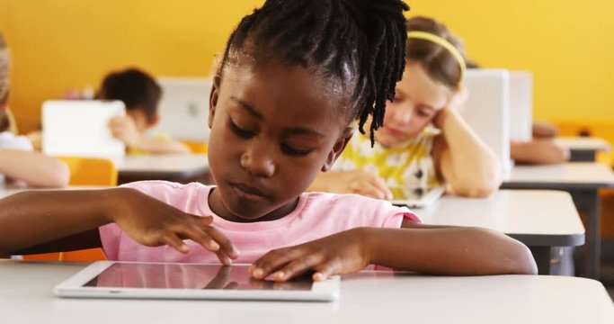 Girl using digital tablet in classroom
