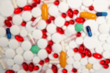 Heap of tablets and pills on white background.
