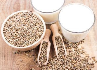 Hemp milk, seeds on wooden background . Close Up .
