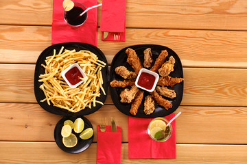 Grilled chicken on a plate standing the wooden table