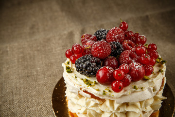 Pavlova, a home made cake from layers of meringue, whipped cream, and fresh berries