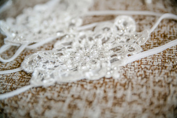 Delicate detail of a wedding dress. Fine lace.