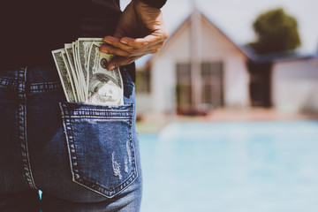 Woman with dollars money in her pocket.