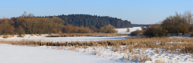 Beautiful winter rural landscape with pond