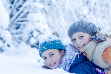 Happy girls having fun with snow