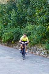 A young guy on a bike outdoors