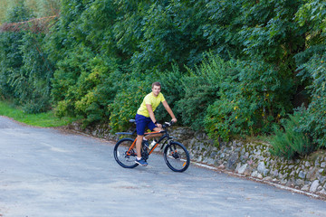 A young guy on a bike outdoors