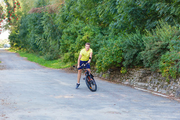 A young guy on a bike outdoors