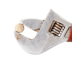 herbal pill on adjustable pliers pipe wrench