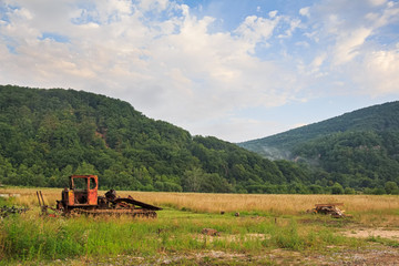 Bulldozer standing on mountain background