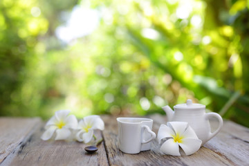 Flowers with heart shaped cup on wooden table