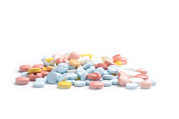 Obraz na płótnie Canvas Heap of colored medicine pills on the light background