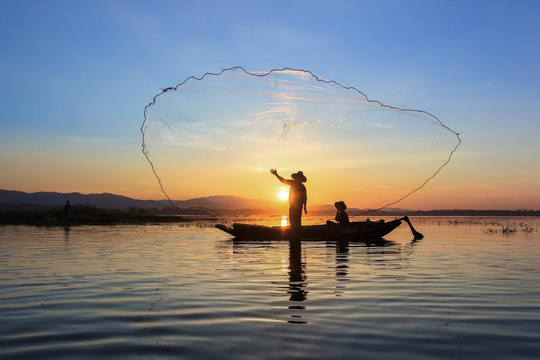 Fishermen fishing in the early morning golden light 