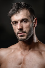 Handsome men face close up portrait in the gym