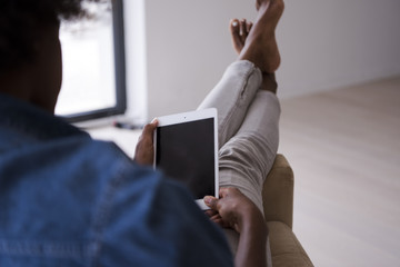 african american woman at home with digital tablet