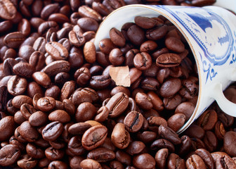 Coffee cup from thin porcelain against the background   grains.