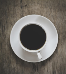 coffee cup on the desk. view from above. Dark background image.