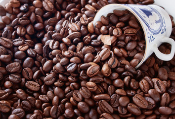 Coffee cup from thin porcelain against the background   grains.