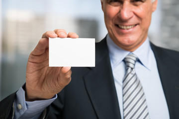 Businessman showing a business card