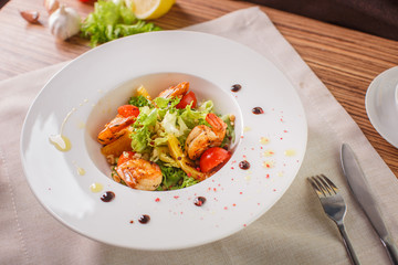 Caesar salad with shrimps and iceberg leaves