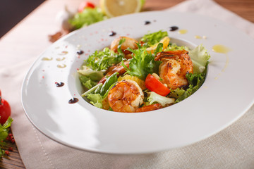 Caesar salad with shrimps and iceberg leaves