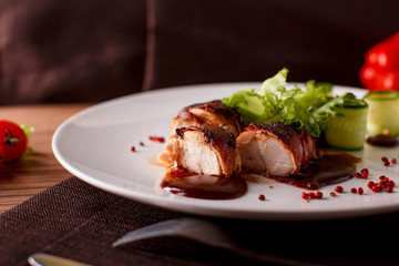 Delicious meat loaf with ketchup on a white plate, macro horizontal
