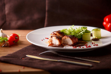 Delicious meat loaf with ketchup on a white plate, macro horizontal