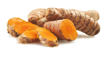 turmeric root and some slices on a white background