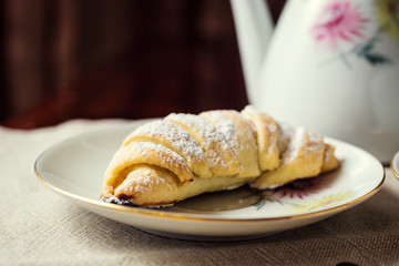 delicious coffee with croissant,a cup of coffee and croissants with coffee beans and cinnamon sticks,breakfast with cup of coffee, croissants and chocolate