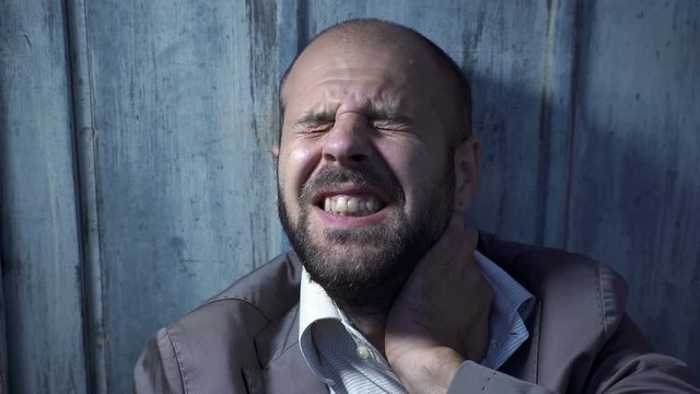 man who lost his job, alone cries leaning against the wall