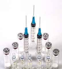 Three medical syringes, vials with dry human hormone powder and ampules with saline. Syringes...