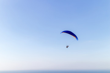 Parachute on blue sky background.